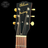 Gibson guitar headstock with brand name on a black background