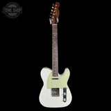 A white electric guitar with a pale green pickguard and a dark brown neck, shown against a solid black background. A circular 'TONE SHOP' watermark is visible in the top-left corner.