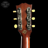 Guitar headstock with Gibson logo on a black background