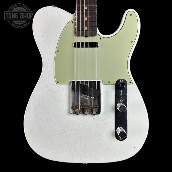 A white Fender Telecaster electric guitar with a light sage green pickguard, shown against a solid black background. The brand logo 'Tone Shop' is visible as an overlay in the top-left corner.