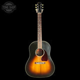 Acoustic guitar with a sunburst finish on a black background, featuring the Tone Shop logo.
