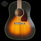 Acoustic guitar with a sunburst finish on a black background, featuring the Tone Shop logo.