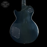 The back of a glossy black electric guitar, showing the body, pickups, and a clear plastic cover over the lower bout, photographed against a solid black background.