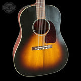 Acoustic guitar with a sunburst finish on a black background, featuring the Tone Shop logo.