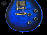 Close-up of a blue electric guitar with visible brand logo in the corner.
