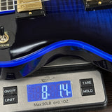 Blue electric guitar on a digital scale displaying weight.