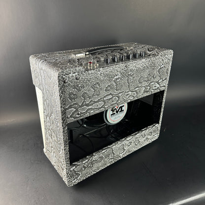 Guitar amplifier with decorative front panel on a gray background