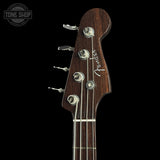 Front of headstock of Fender Custom Shop Postmodern Precision Bass RW DLX Closet Classic Ebony Transparent.