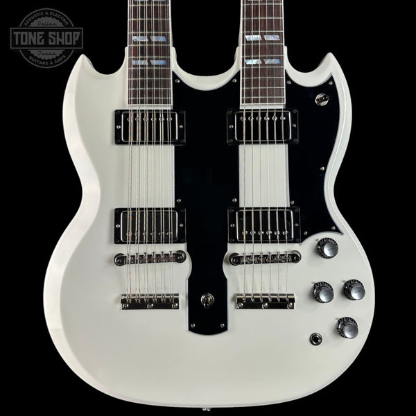 White electric guitar with multiple pickups on a black background, featuring 'Tone Shop' logo.