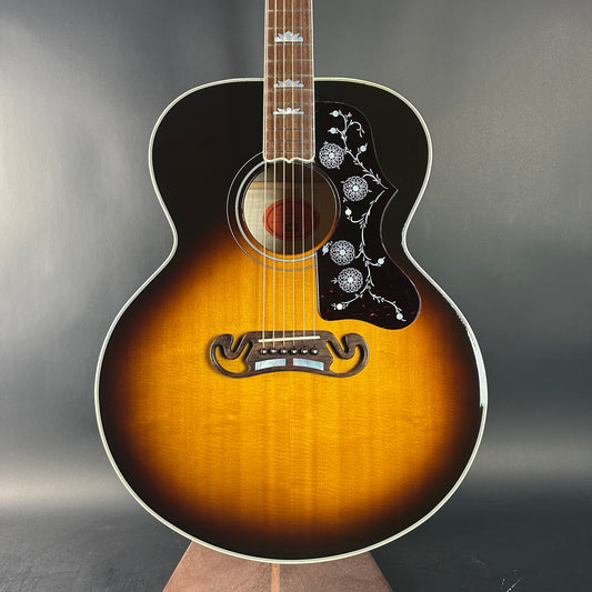 Acoustic guitar with a sunburst finish on a gray background