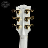 Gibson guitar headstock with tuning pegs on a black background