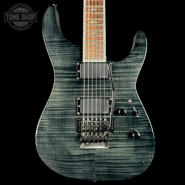 Electric guitar with a black and gray pattern on a black background, featuring the Tone Shop logo.