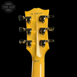 Gibson guitar headstock with tuning pegs on a black background