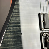 Close-up of a guitar with a focus on the body and electronics.