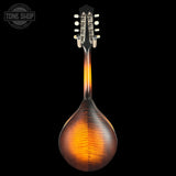 A close-up studio shot of a mandolin's back, showing a glossy sunburst finish that transitions from dark brown to bright amber-orange, with a black headstock and silver tuning pegs, set against a solid black background.