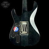 Black electric guitar with a visible brand logo on a black background