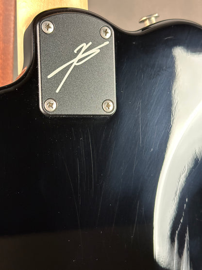 Close-up of a guitar with a brand logo on the body