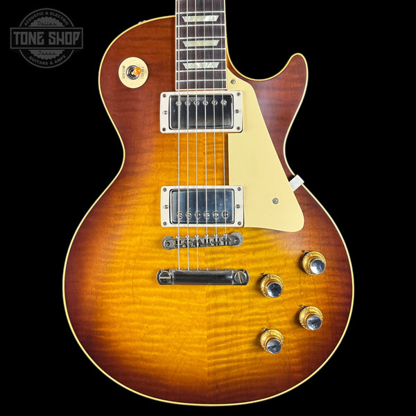 Electric guitar with a sunburst finish on a black background, featuring the Tone Shop logo.