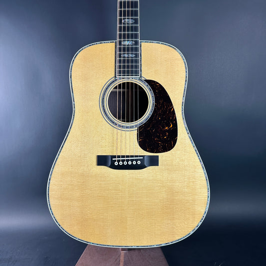 Acoustic guitar with a wooden finish on a dark blue background