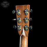 Close-up of the back of a guitar headstock with six tuning pegs and decorative metal tuners on a black background. A Tone Shop watermark is visible in the top left corner.