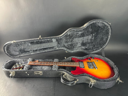 Electric guitar in a hard-shell case on a gray background