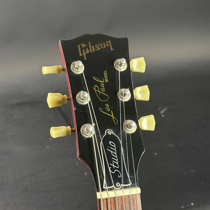 Gibson Les Paul Studio headstock on a dark background