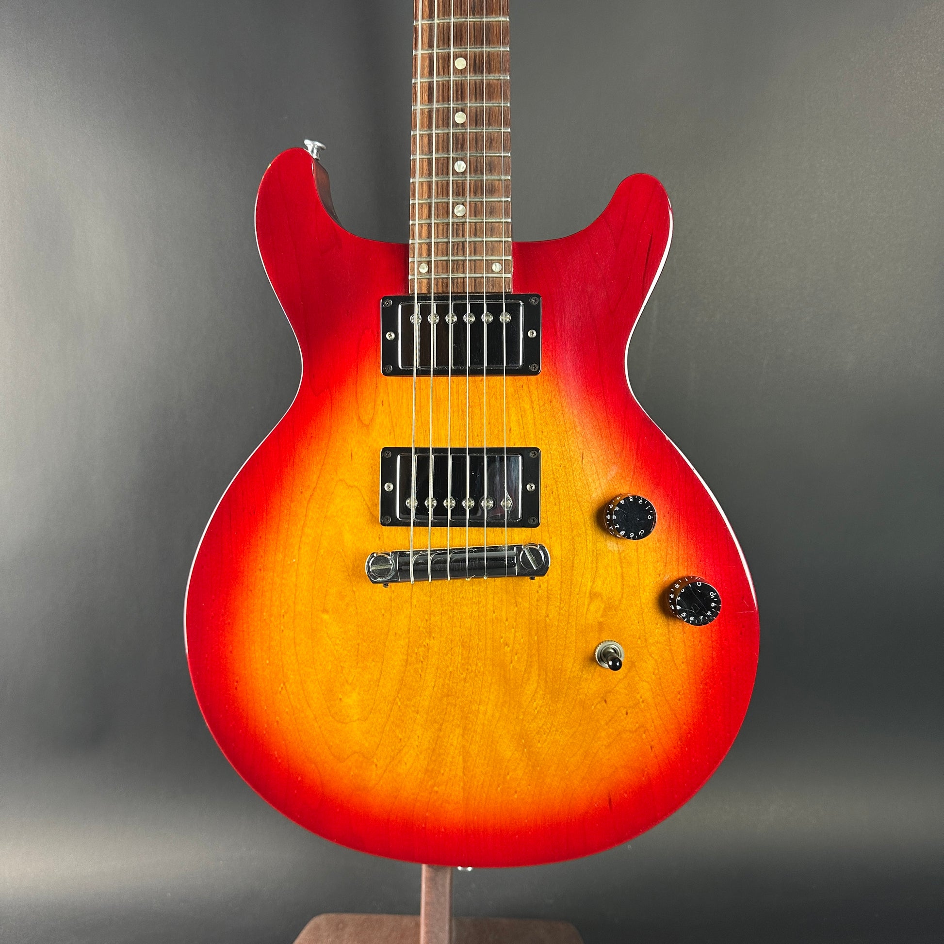 Electric guitar with a sunburst finish on a gray background