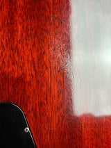 Close-up of a wooden surface with scratches and a black object on it