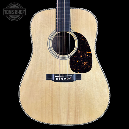 Acoustic guitar with a visible brand logo on a black background