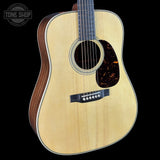Acoustic guitar with a visible brand logo in the corner