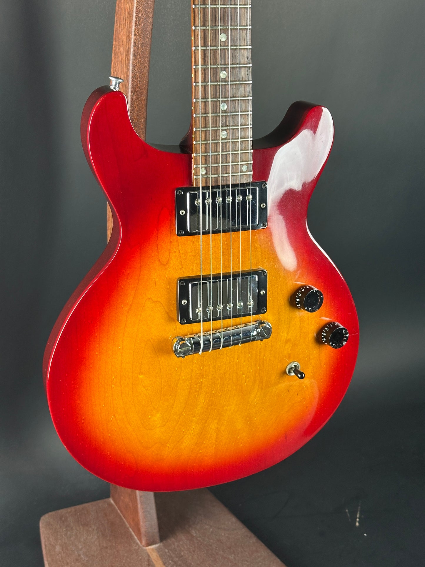 Electric guitar with a sunburst finish on a dark background