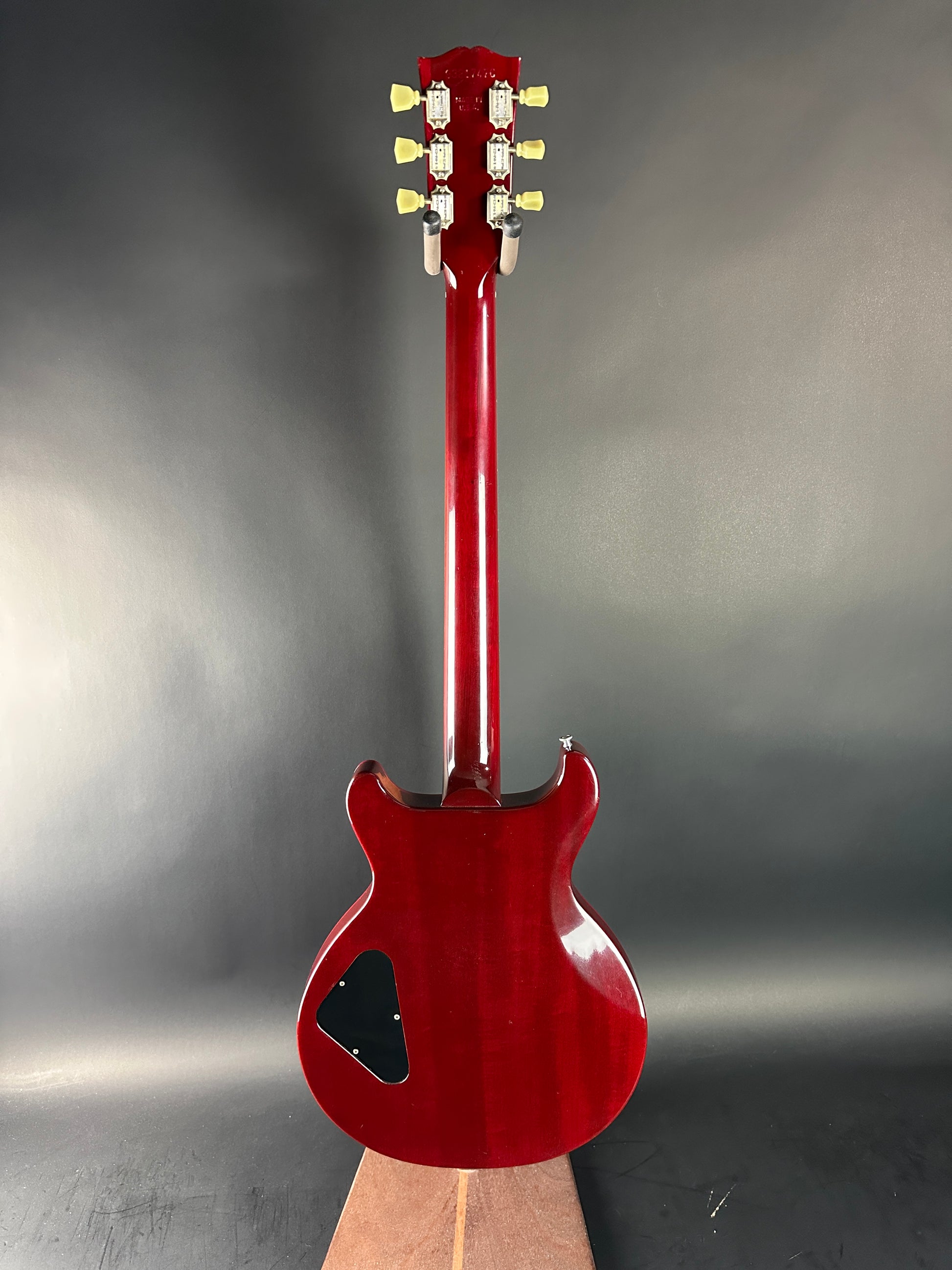 Red electric guitar on a gray background