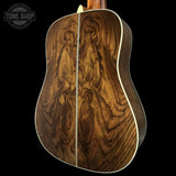 Wooden acoustic guitar back with 'Tone Shop' logo in the corner