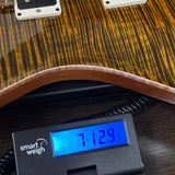 Used PRS 40th Anniversary Custom 24 Limited Edition Tiger Eye on scale displaying weight.