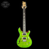 A green flamed maple electric guitar with a black neck and headstock, shown against a solid black background. A Tone Shop watermark is visible in the top-left corner.