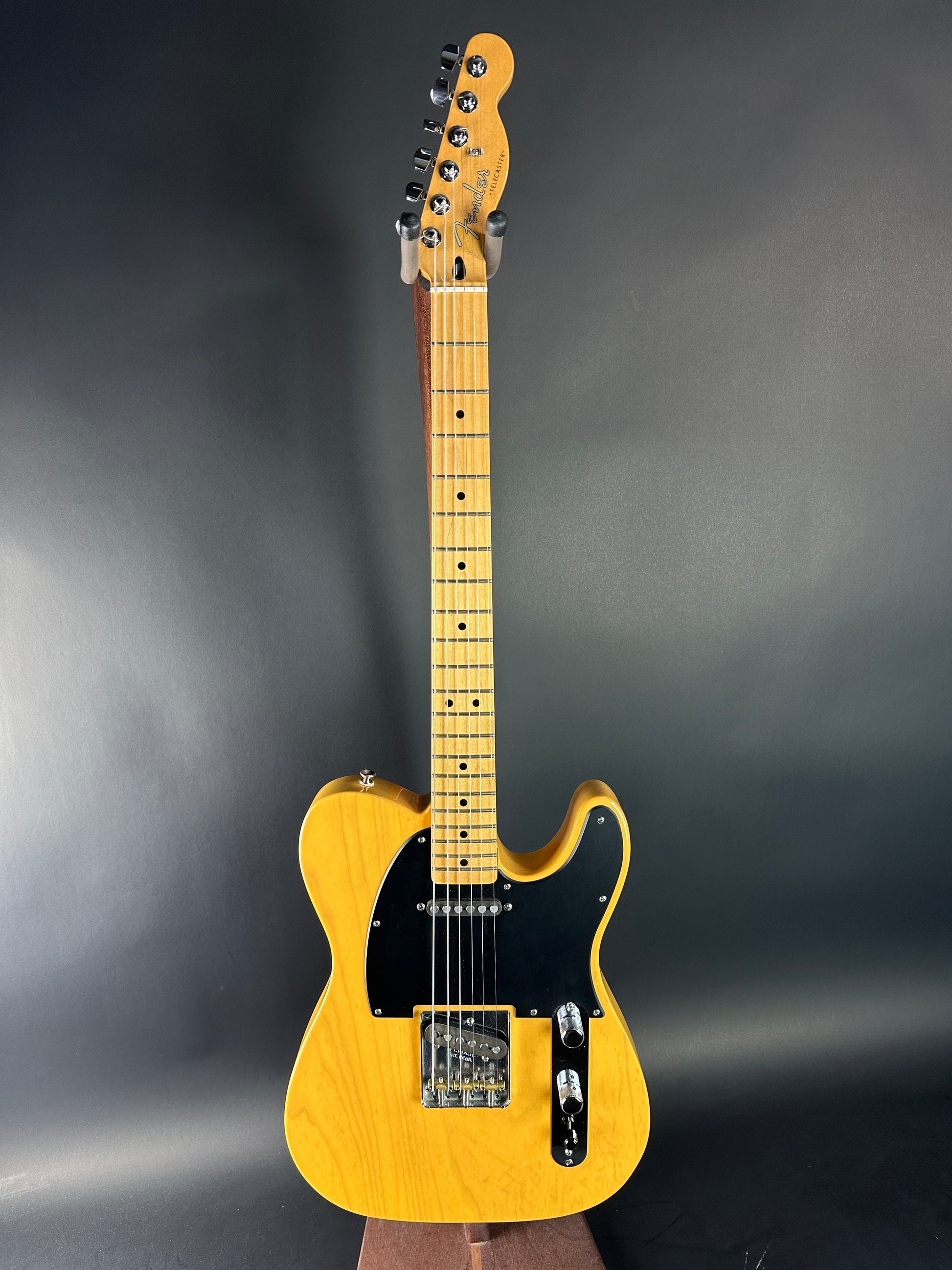 Yellow electric guitar on a dark gray background