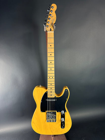 Yellow electric guitar on a dark gray background