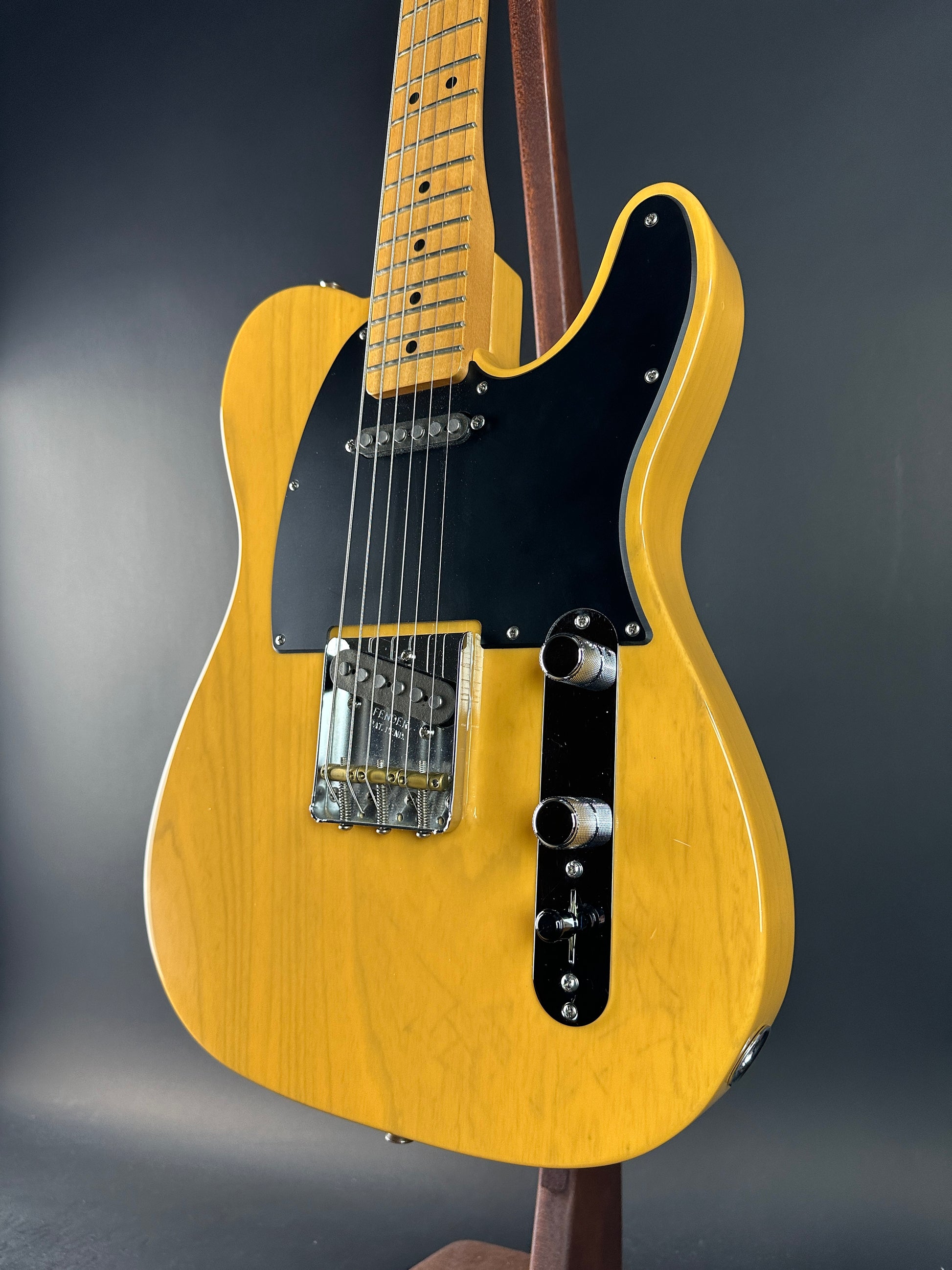 Yellow electric guitar on a dark gray background