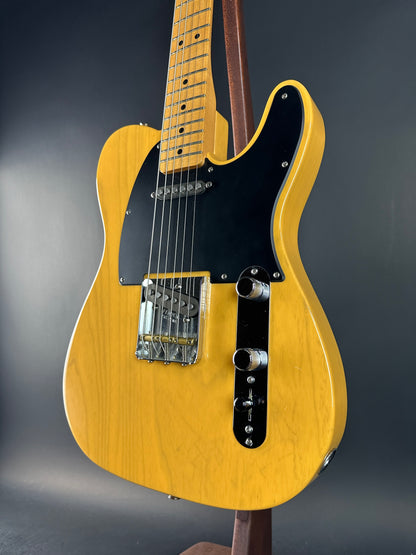Yellow electric guitar on a dark gray background