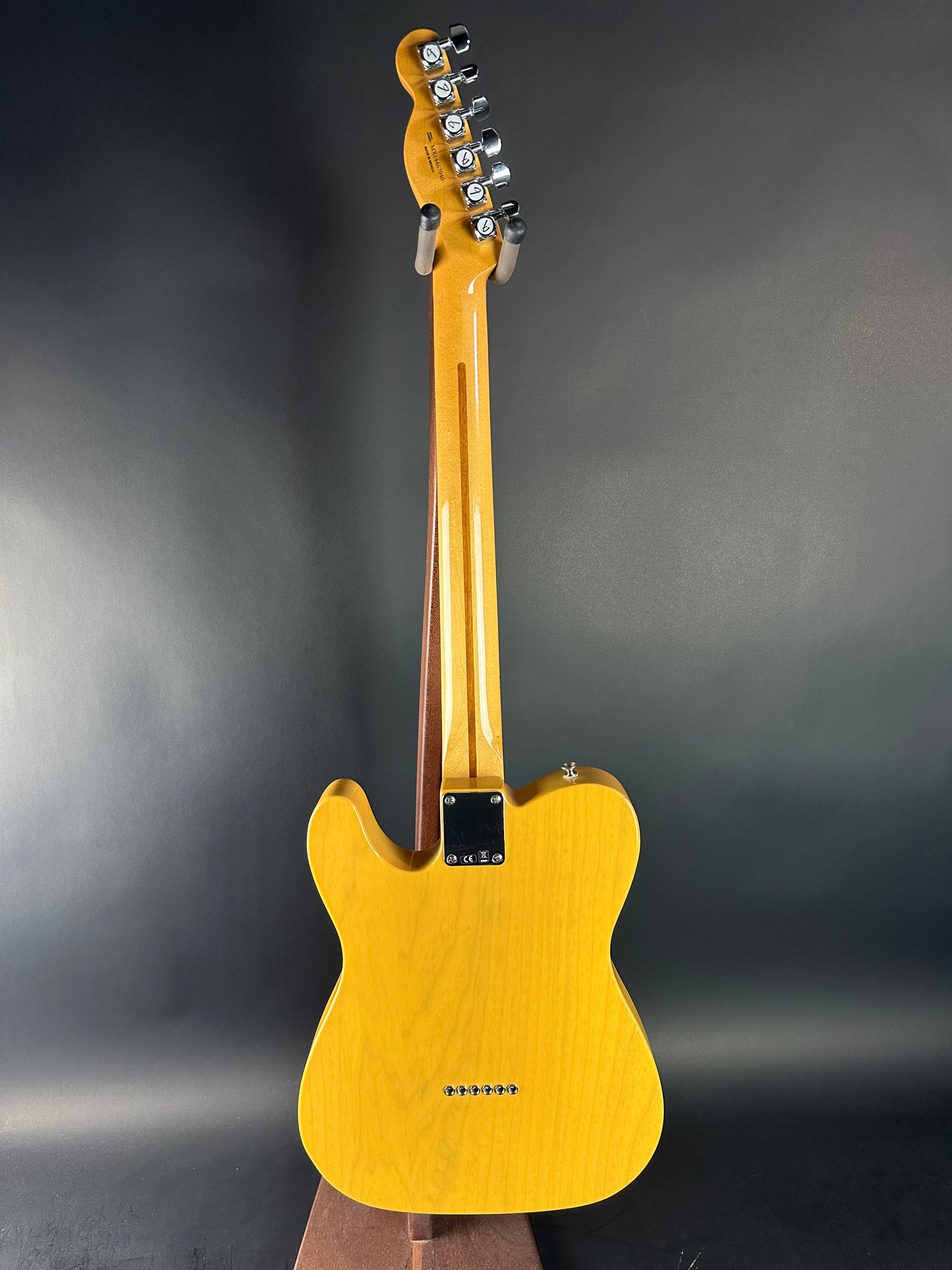 Yellow electric guitar on a dark gray background