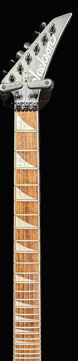 Close-up of a guitar neck with a dark background