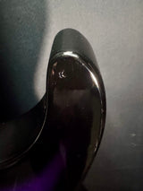Close-up of a shiny black object on a gray background