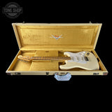 Fender electric guitar in a gold case with Fender logo.