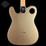 The back of a gold-finish Telecaster-style electric guitar body with a black pickguard, six screws, and a light wood neck visible at the top, shown against a black background.