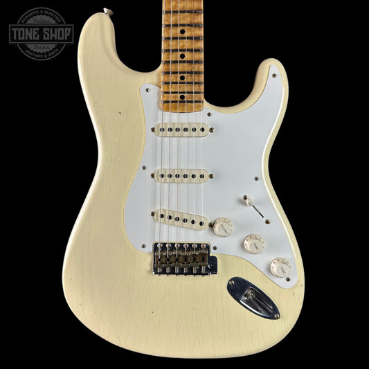 White electric guitar with a visible brand logo on a black background