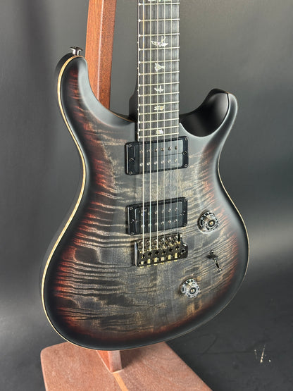 Electric guitar with a wood finish on a dark background