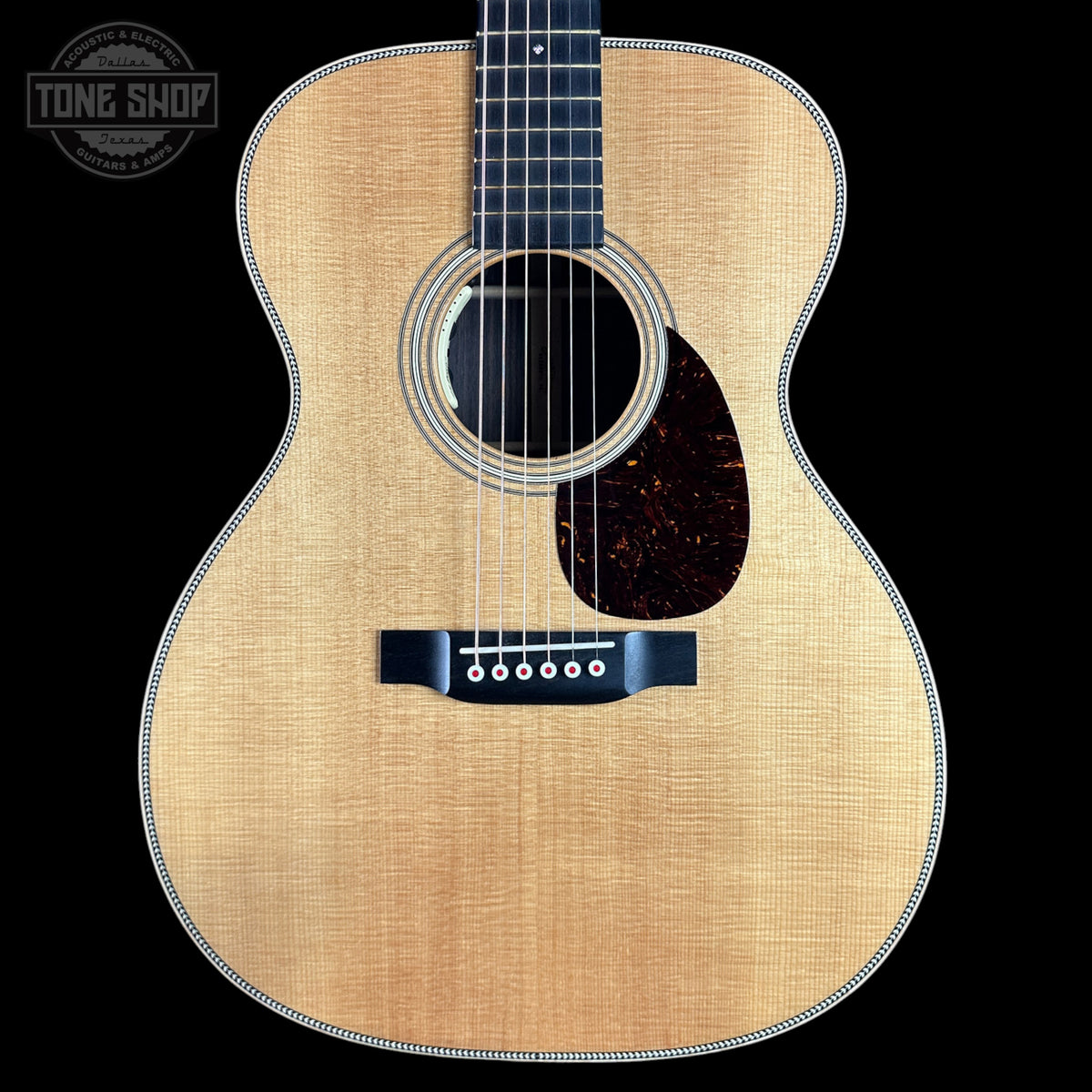 Acoustic guitar with a visible brand logo in the corner