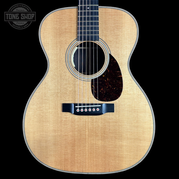 Acoustic guitar with a visible brand logo in the corner