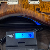 2024 PRS Paul Reed Smith CE24 Semi-Hollow Quilt Black Amber on scale displaying weight.