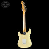 White electric guitar on a black background with 'Tone Shop' logo.